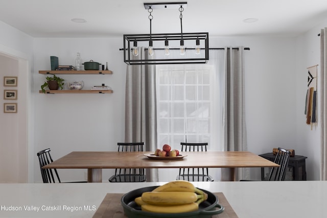 dining space with an inviting chandelier