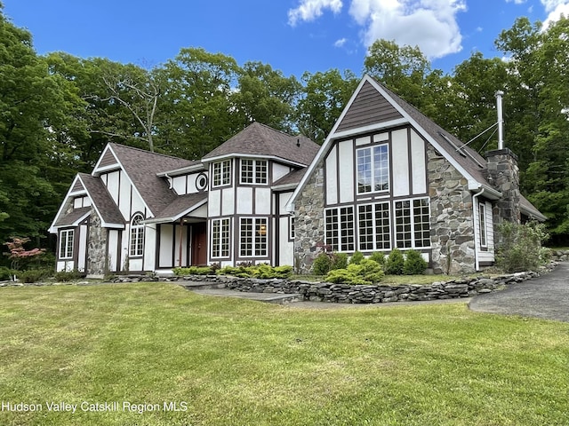 71 Saddleback Ridge Rd, Shawangunk, NY 12589 - rear view of house with stone siding, a yard, roof with shingles, and stucco siding