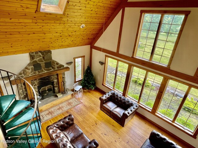 71 Saddleback Ridge Rd, Shawangunk, NY 12589 - living room with high vaulted ceiling, a skylight, a stone fireplace, wood finished floors, and wood ceiling