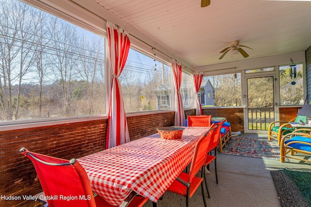 sunroom / solarium featuring ceiling fan