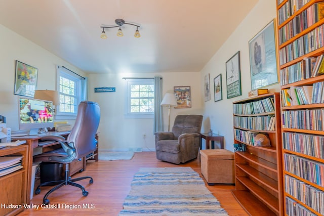 office space featuring baseboards and wood finished floors