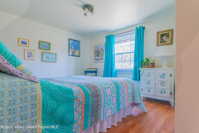 bedroom featuring wood finished floors