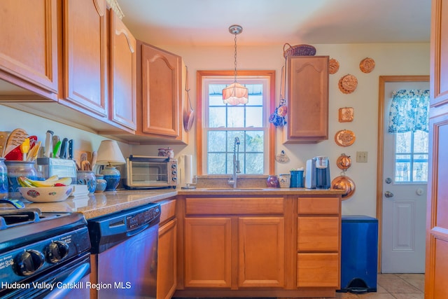 kitchen featuring a sink, a toaster, dishwashing machine, stainless steel range with gas stovetop, and hanging light fixtures