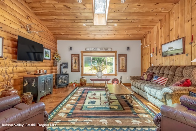 1063 Ferris Hill Rd, Roxbury, NY 12474 - living area with a wood stove, wood ceiling, wood finished floors, rustic walls, and lofted ceiling