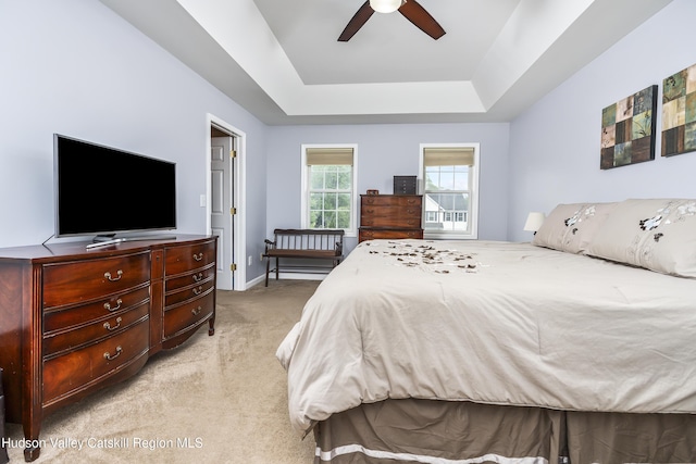 16 Shinnecock Hills Dr, Colonie, NY 12205 - bedroom with light colored carpet, a tray ceiling, baseboards, and ceiling fan