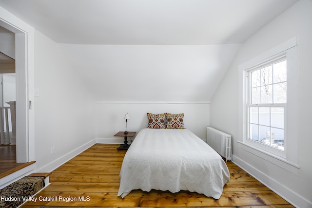 27 Sands Ave, Milton, NY 12547 - bedroom with radiator, vaulted ceiling, wood-type flooring, and baseboards