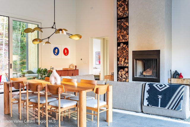 120 Old Quarry Rd, Catskill, NY 12414 - dining room featuring concrete floors, a towering ceiling, and a fireplace