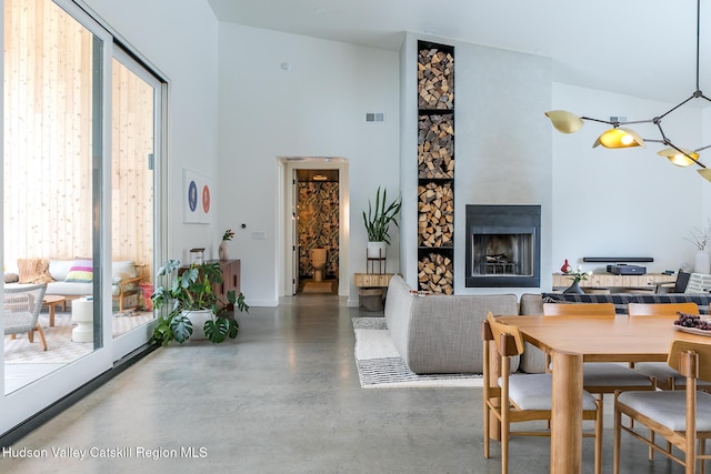 120 Old Quarry Rd, Catskill, NY 12414 - dining space with concrete flooring, a fireplace, and a towering ceiling