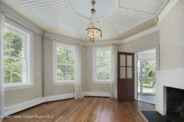 55 Leggett Rd, Stone Ridge, NY 12484 - foyer with crown molding, hardwood / wood-style floors, a brick fireplace, a raised ceiling, and a baseboard heating unit