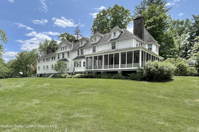 55 Leggett Rd, Stone Ridge, NY 12484 - back of property featuring a sunroom, a chimney, a yard, and roof with shingles