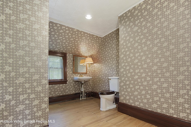 55 Leggett Rd, Stone Ridge, NY 12484 - half bath featuring crown molding, wood finished floors, toilet, baseboards, and wallpapered walls