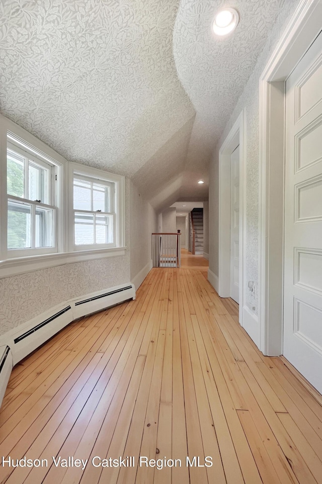 55 Leggett Rd, Stone Ridge, NY 12484 - additional living space with hardwood / wood-style flooring, vaulted ceiling, and a textured ceiling
