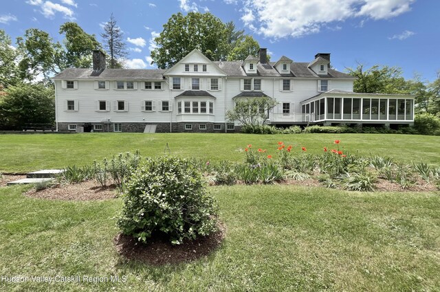 55 Leggett Rd, Stone Ridge, NY 12484 - back of house with a sunroom, a chimney, and a lawn