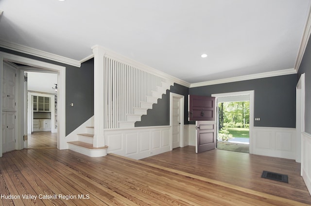 55 Leggett Rd, Stone Ridge, NY 12484 - unfurnished living room with hardwood / wood-style flooring, stairs, ornamental molding, a decorative wall, and wainscoting