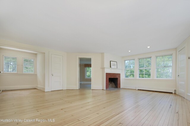 55 Leggett Rd, Stone Ridge, NY 12484 - unfurnished living room featuring baseboard heating, plenty of natural light, light wood finished floors, and recessed lighting