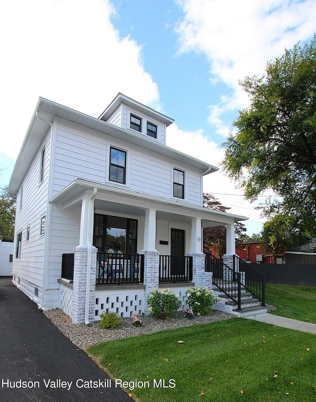 view of front of house with a porch and a front lawn