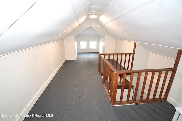 additional living space with dark hardwood / wood-style flooring and vaulted ceiling