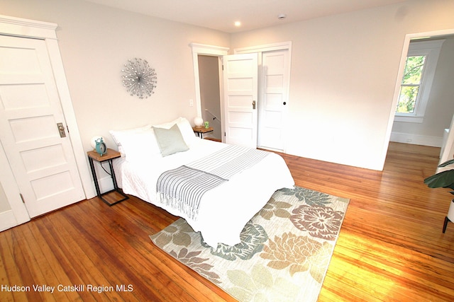 bedroom with wood-type flooring and a closet