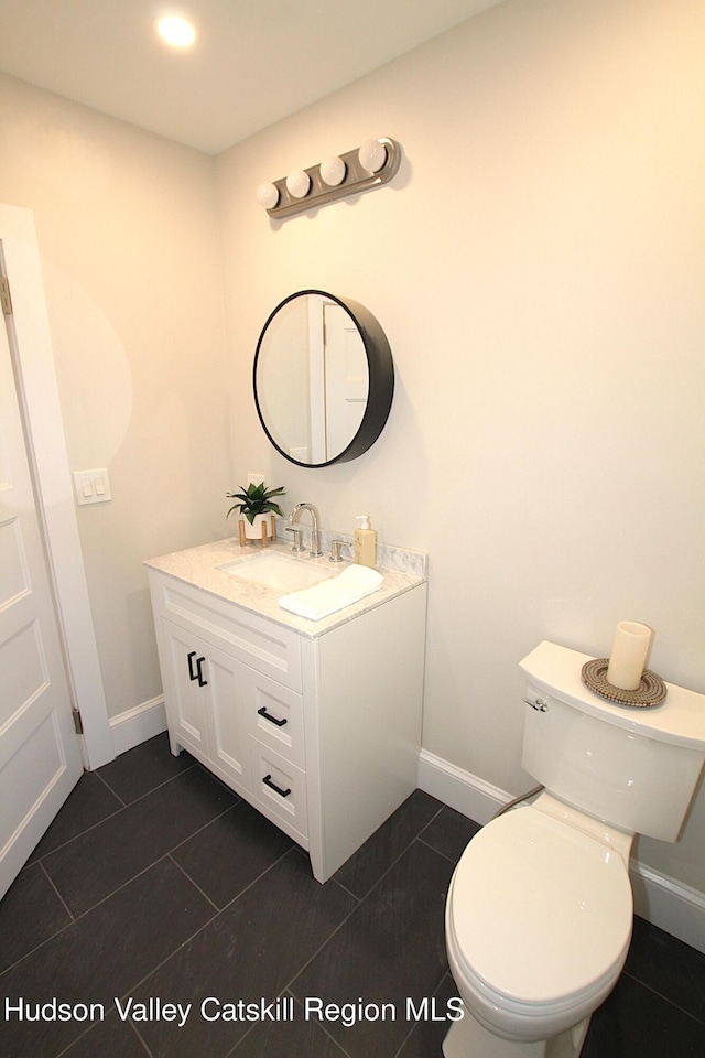 bathroom featuring tile patterned flooring, vanity, and toilet