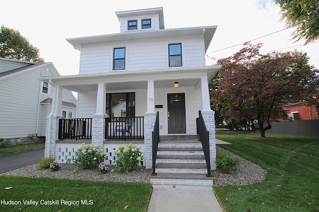 view of front of house featuring a front lawn and covered porch