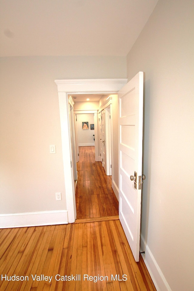 corridor featuring wood-type flooring