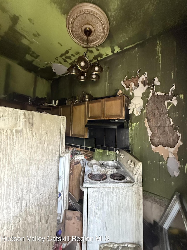 477 Main St, Catskill, NY 12414 - kitchen featuring under cabinet range hood, electric stove, and brown cabinetry