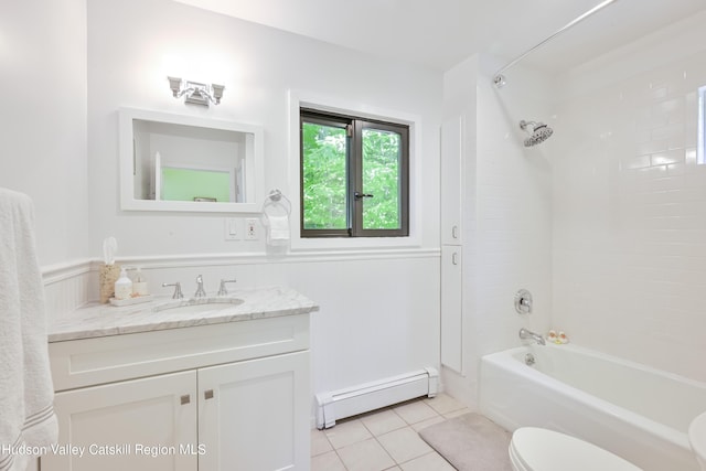 full bathroom with vanity, tiled shower / bath combo, a baseboard radiator, tile patterned flooring, and toilet