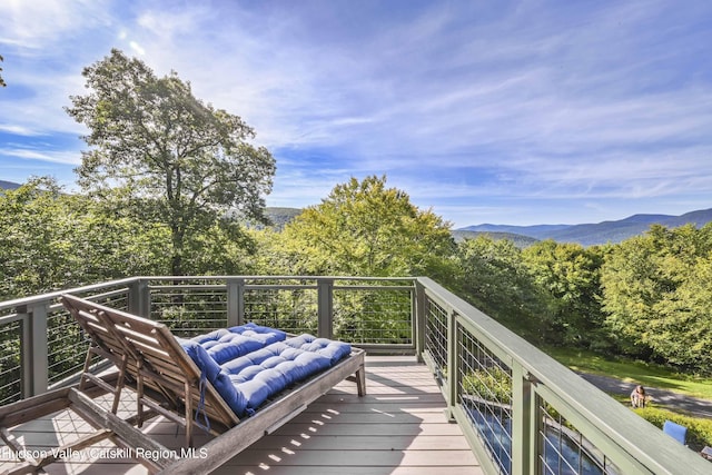 wooden deck with a mountain view