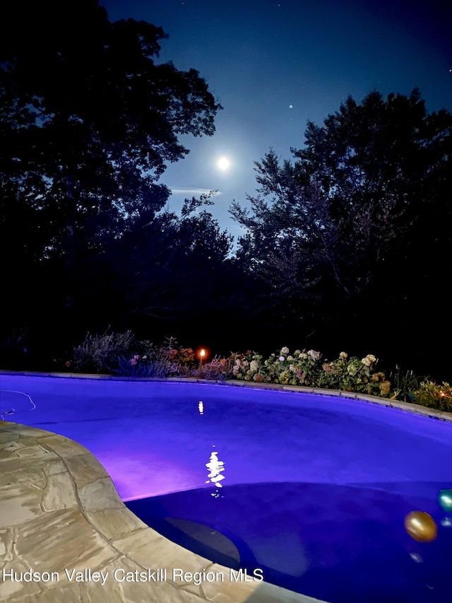 view of pool at night