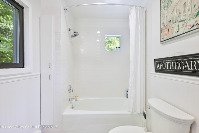 bathroom with toilet and shower / tub combo with curtain