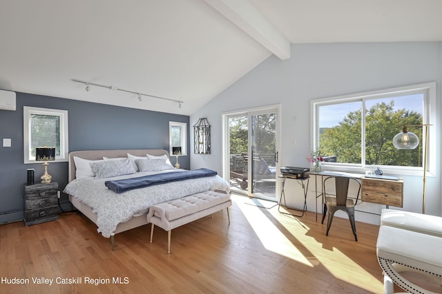 bedroom with a wall unit AC, access to exterior, light hardwood / wood-style flooring, and vaulted ceiling with beams