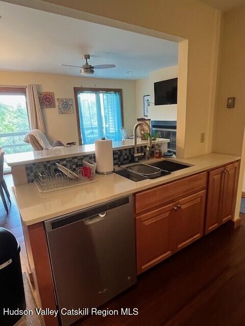 45 Windham Ridge Rd Unit 15C, Windham, NY 12496 - kitchen featuring stainless steel dishwasher, a sink, light countertops, dark wood-style flooring, and open floor plan