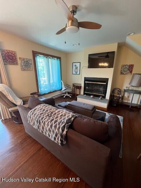 45 Windham Ridge Rd Unit 15C, Windham, NY 12496 - living area featuring ceiling fan, wood finished floors, and a glass covered fireplace