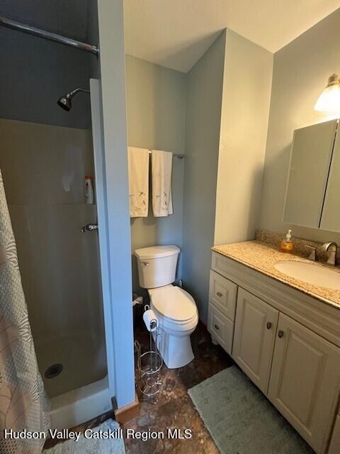 45 Windham Ridge Rd Unit 15C, Windham, NY 12496 - full bath featuring a shower with shower curtain, vanity, and toilet