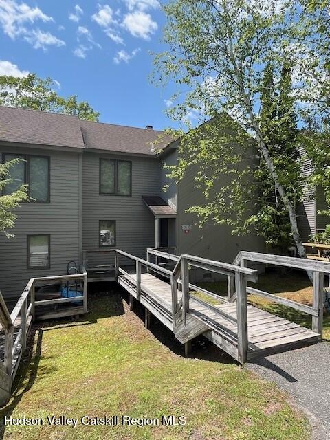 45 Windham Ridge Rd Unit 15C, Windham, NY 12496 - rear view of house with a lawn, a wooden deck, and a shingled roof