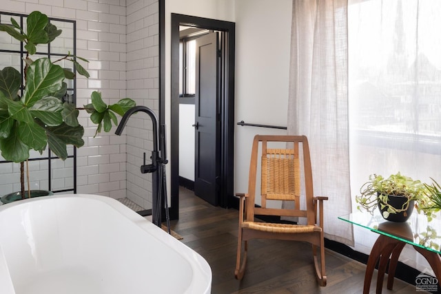 352 Columbia St, Hudson, NY 12534 - bathroom featuring a sink, wood finished floors, and a freestanding tub