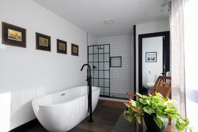 352 Columbia St, Hudson, NY 12534 - bathroom featuring a shower stall, wood finished floors, a freestanding tub, toilet, and recessed lighting