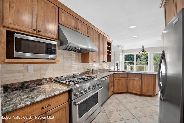 172 Shields Rd, Red Hook, NY 12571 - kitchen with appliances with stainless steel finishes, under cabinet range hood, brown cabinets, light tile patterned floors, and backsplash
