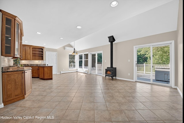 172 Shields Rd, Red Hook, NY 12571 - unfurnished living room with lofted ceiling, healthy amount of natural light, light tile patterned floors, a wood stove, and recessed lighting