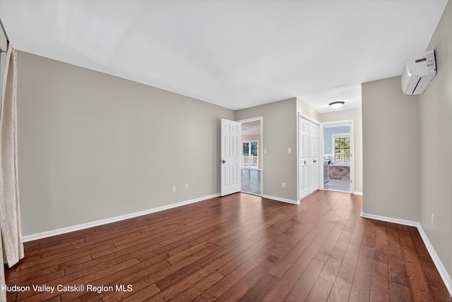 172 Shields Rd, Red Hook, NY 12571 - empty room with a wall mounted AC and dark wood-style floors