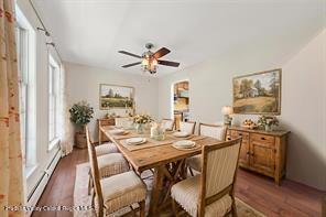 172 Shields Rd, Red Hook, NY 12571 - dining area featuring a baseboard heating unit, plenty of natural light, and dark wood-style flooring