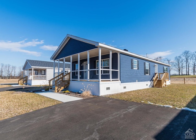 manufactured / mobile home featuring crawl space, a front yard, and a porch