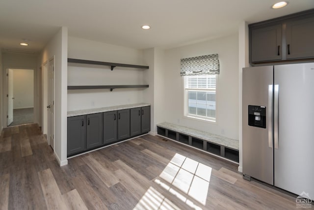 mudroom featuring light wood-style flooring, recessed lighting, and baseboards