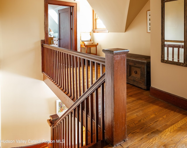 stairway with hardwood / wood-style flooring