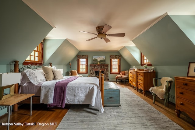 bedroom with hardwood / wood-style flooring, ceiling fan, and lofted ceiling