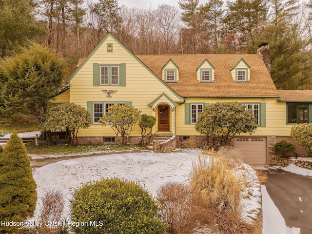 new england style home featuring a garage