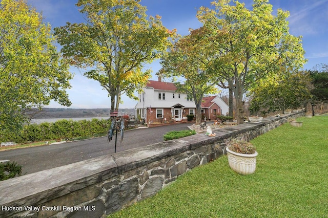 view of front of home featuring a water view and a front yard