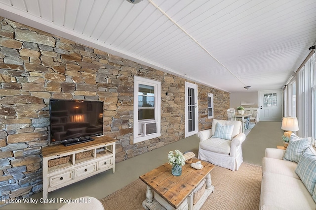 carpeted living room with wooden ceiling