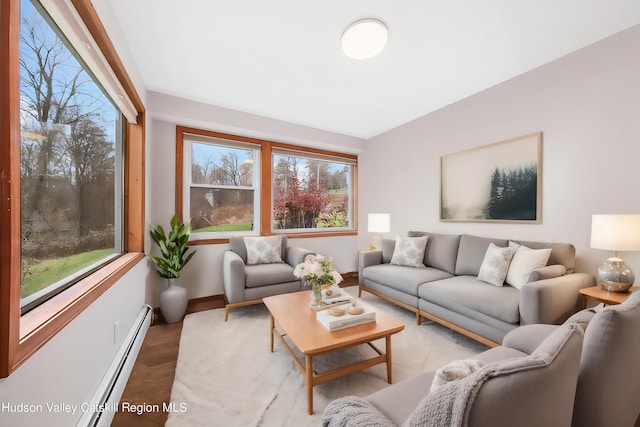 living room featuring hardwood / wood-style flooring and a baseboard heating unit