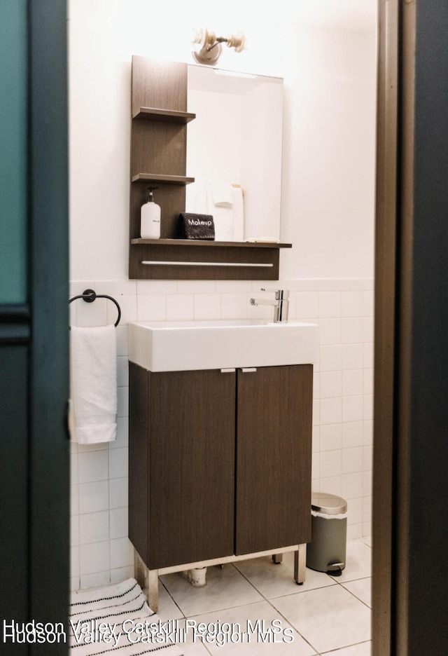 bathroom with vanity, tile patterned floors, and tile walls